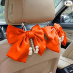 2PCS Satin Bow Pearl Car Seat Headrest Hooks – Car Bag Holder & Vehicle Hanger for Purses – Cute Coquette Aesthetic Interior Decoration – Cute Auto Organizer Accessories Universal (Orange)